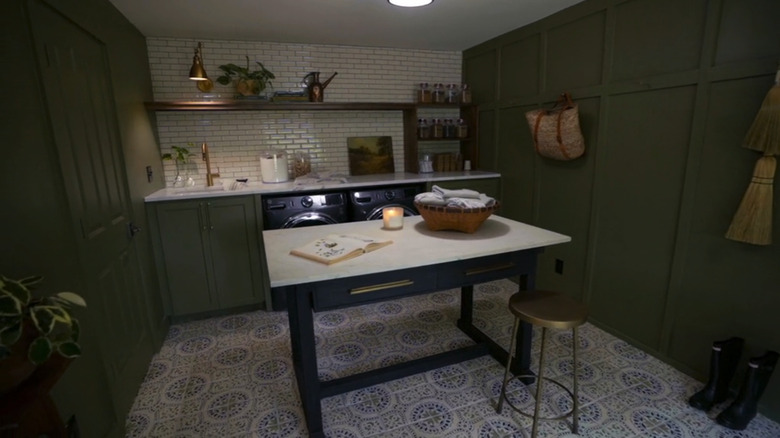 cabinets in laundry with table and chair