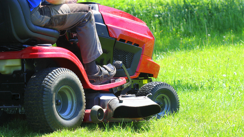 Person sitting on lawn mower