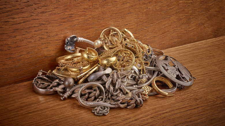 A pile of tarnished silver and gold jewelry