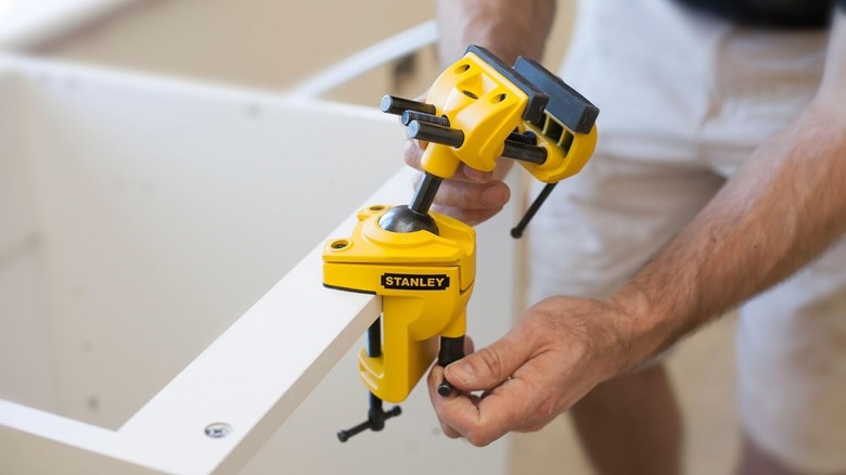 A man tightens a Stanley multi-angle hobby vice