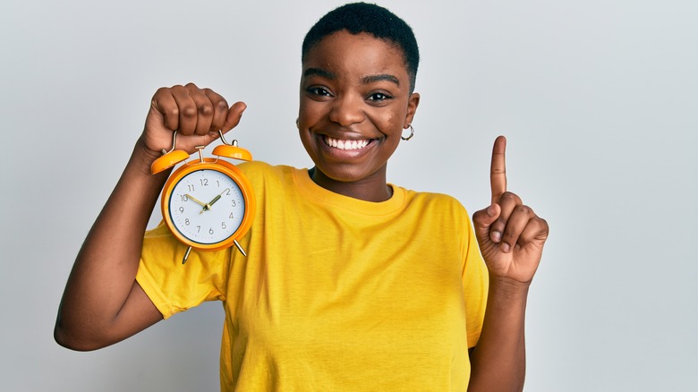 woman holding clock