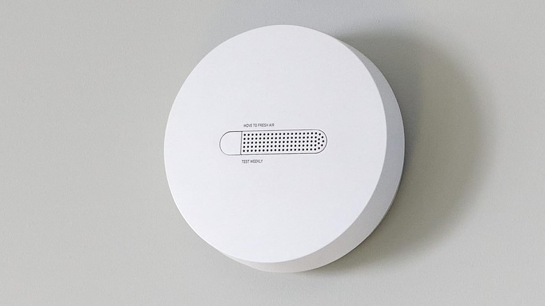 SimpliSafe smart smoke detector on wall