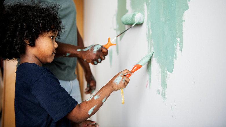 Father and son paint walls