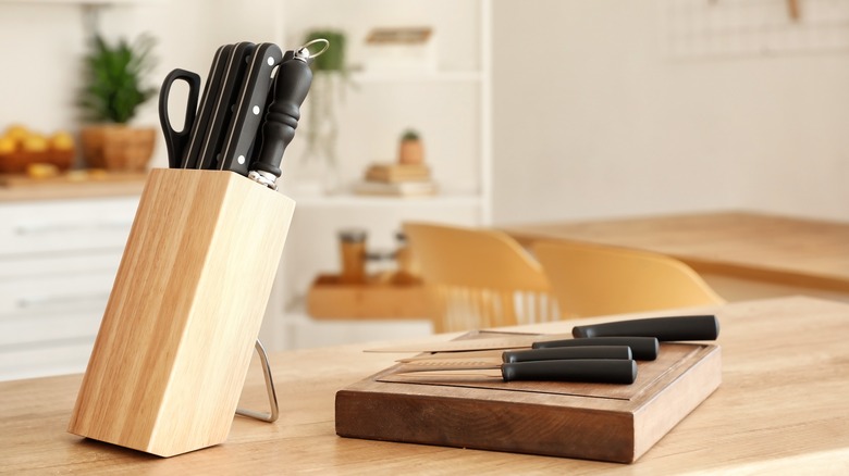 Block of knives and cutting board kitchen counter