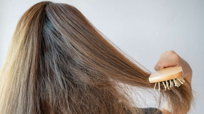 woman brushing her hair 