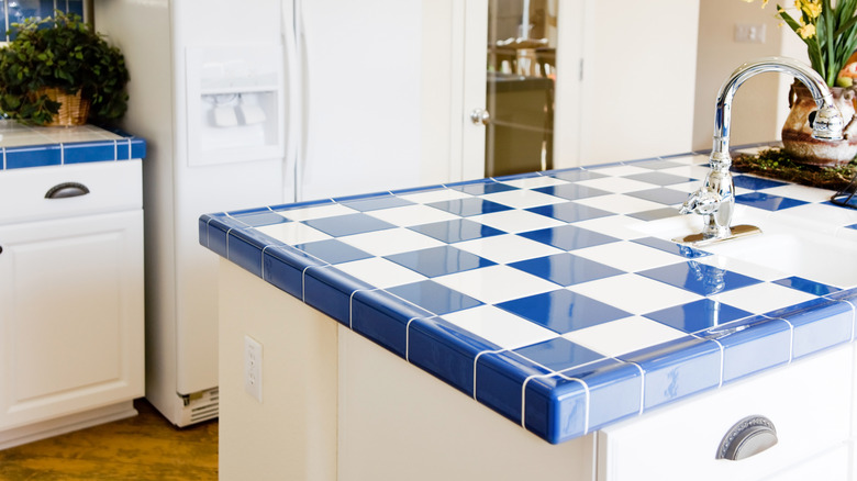 A blue and white tile countertop island in a kitchen