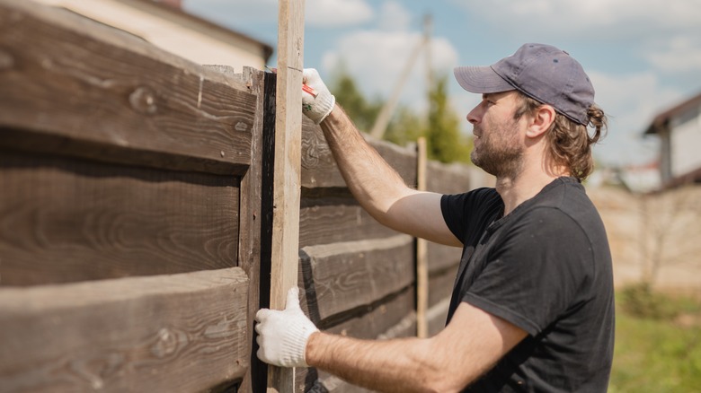 Man installing fence panels