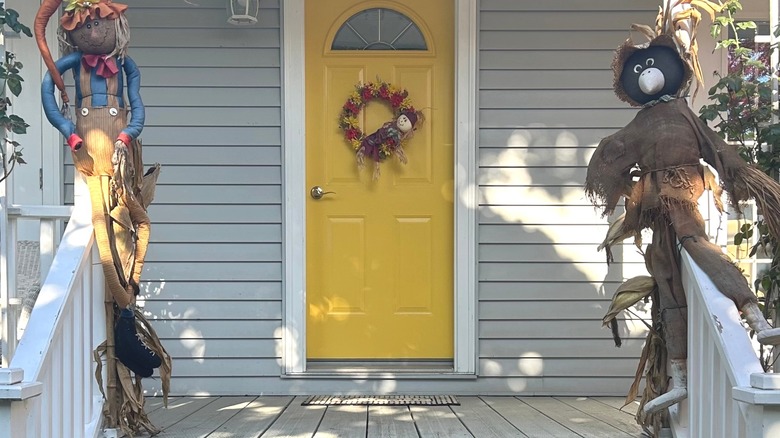 Home with gray siding and a yellow front door