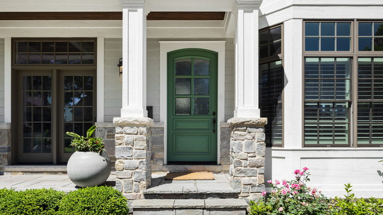 Light gray house with an earthy green front door