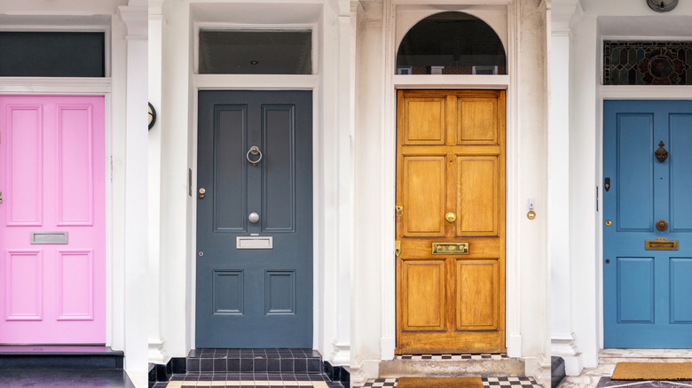 Building with pink, gray, wood, and blue exterior doors