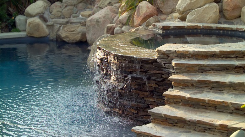 Stone surrounded pool and hot tub