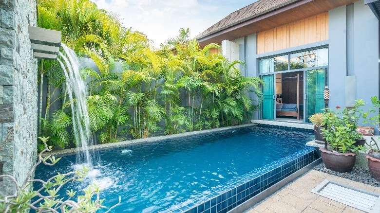 Pool with water cascading from building