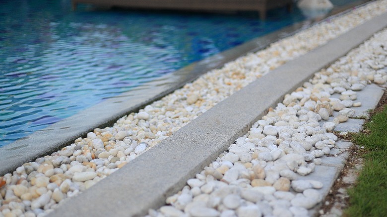 White pebbles around pool