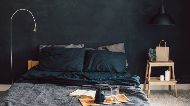 black room with dark bedding