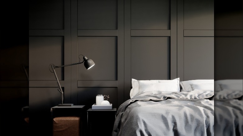 black paneling behind bed