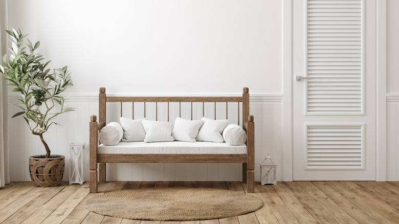 wooden bench with white cushions