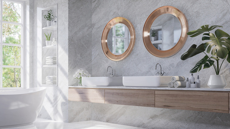 bathroom with gold mirrors