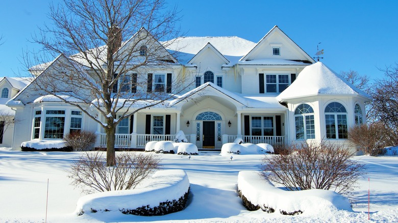 white country mansion in snow