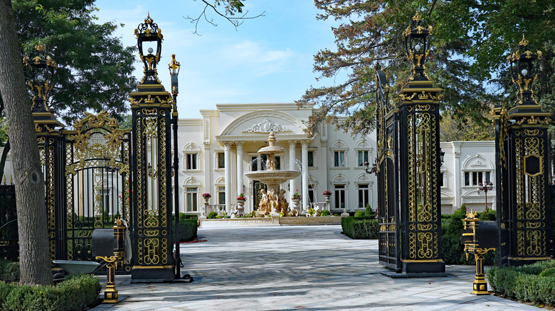 gold and black gate in front of mansion