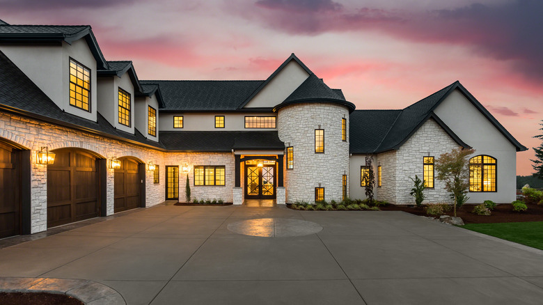 L-shaped mansion with lights on