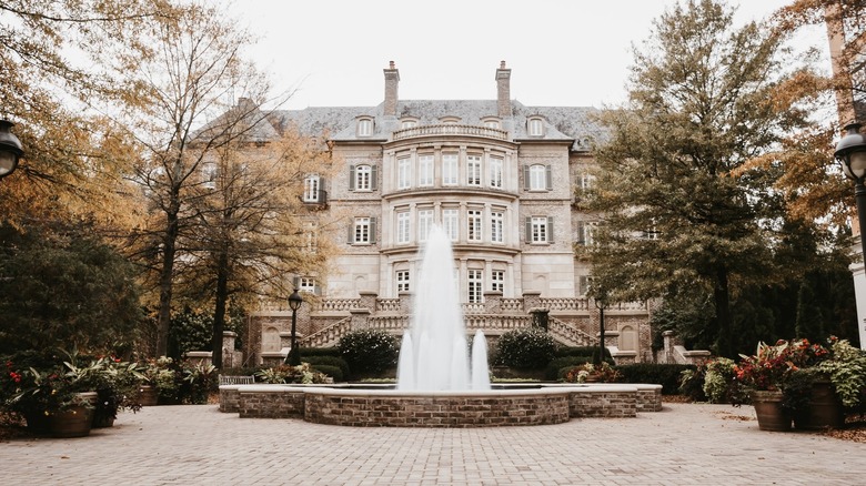 fountain in front of a mansion