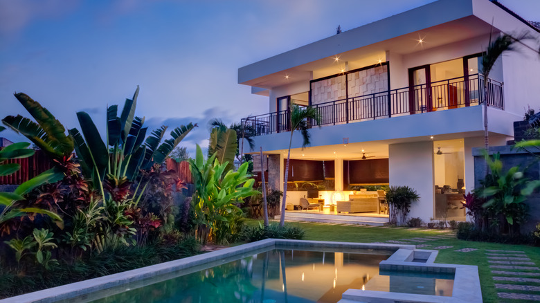 mansion with tropical plants and pool