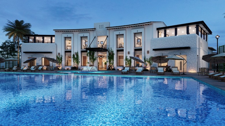 symmetrical white mansion with pool