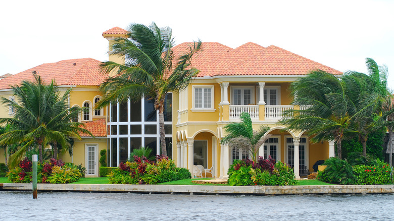 yellow mansion with palm trees