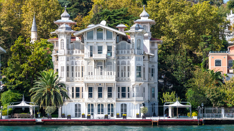 massive white mansion on the water
