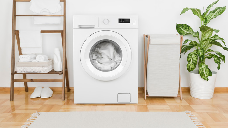 laundry room with wood floors 