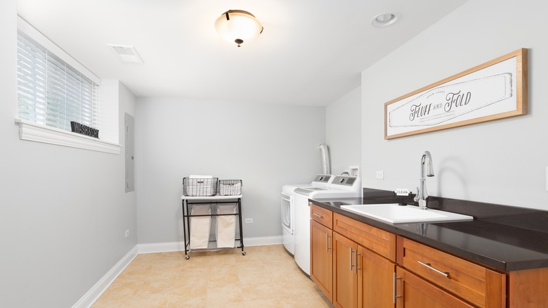 laundry room with wood cabinets 