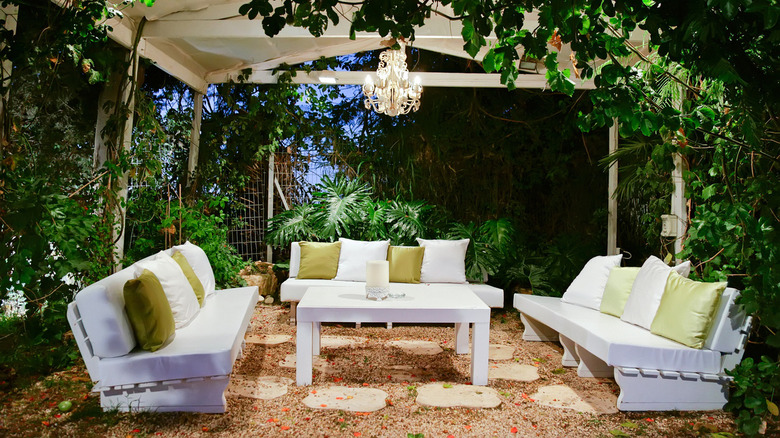 white couches with plants surrounding