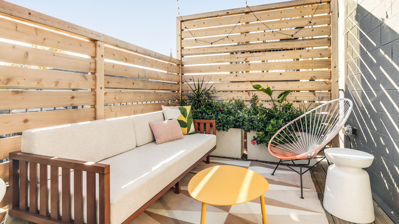 white couch with surrounding fence