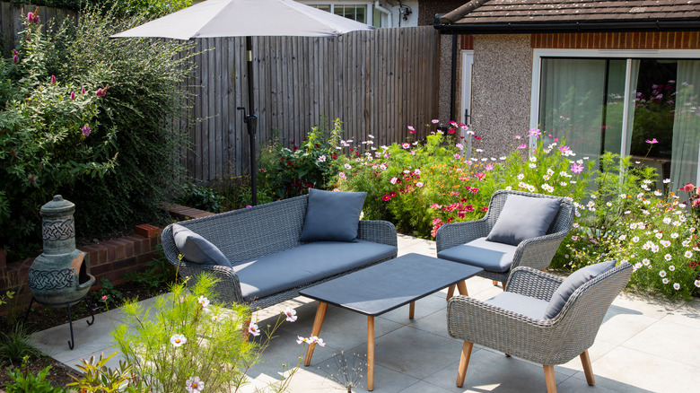 patio furniture between flower beds