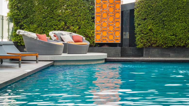 chairs on a platform by a pool