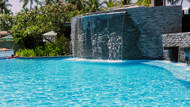 large waterfall by a pool