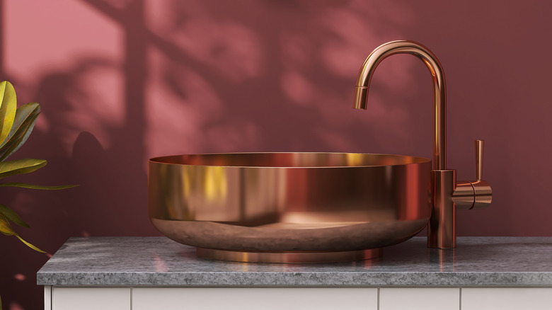 Dark maroon wall brass sink