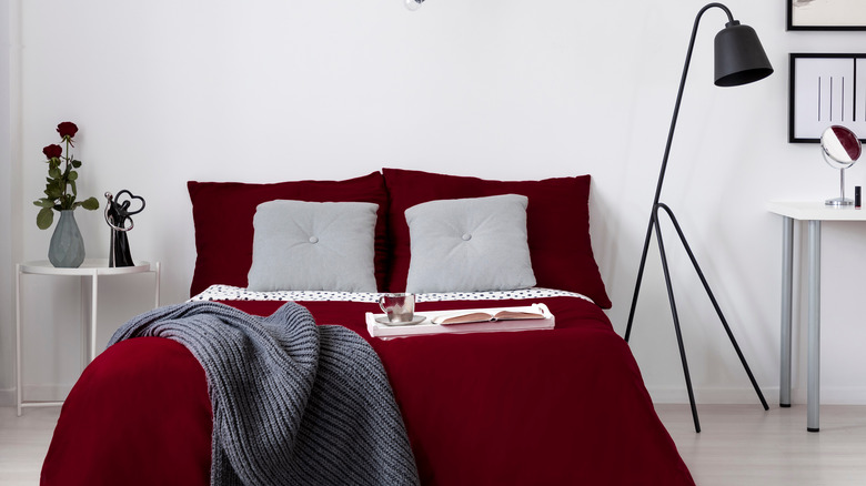 burgundy bedding in white bedroom