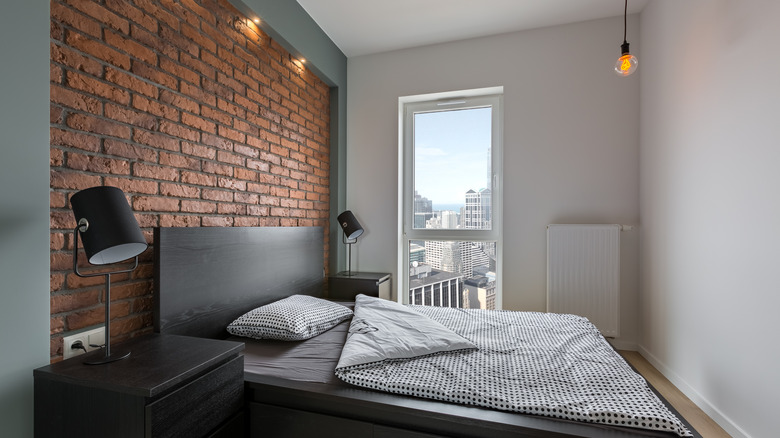 neutral bedroom with brick wall