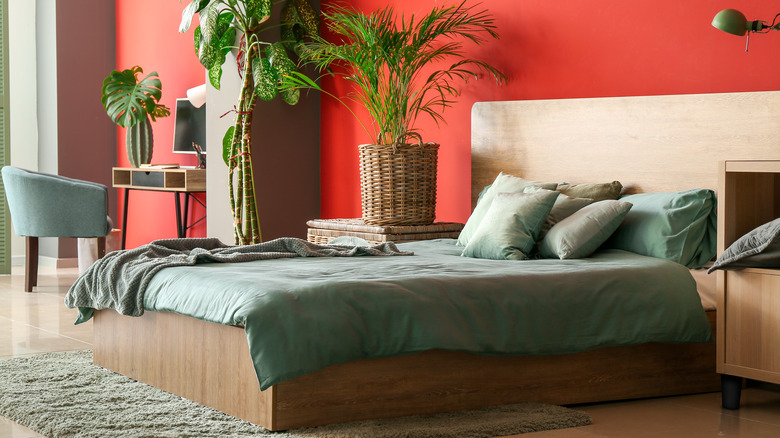 green bedding in red bedroom