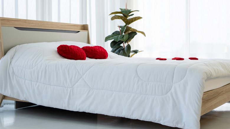 bed with red heart pillows