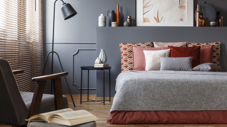 gray-blue bedroom with red bedding