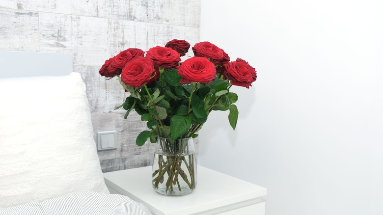 red roses on bedside table