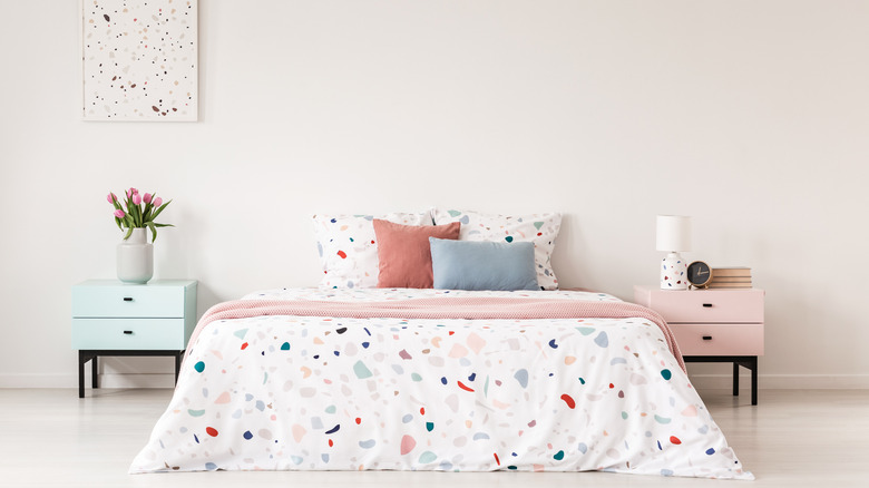 pastel bedroom with speckled bedding