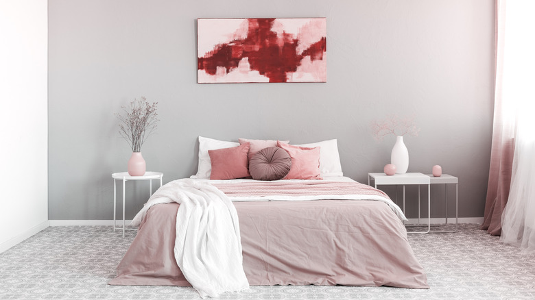 pink bedroom with red art