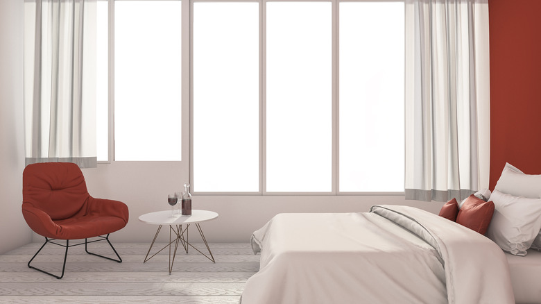 white bedroom with red accents