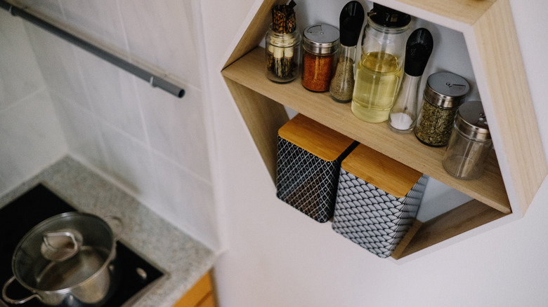 Wall mounted spice rack near stove