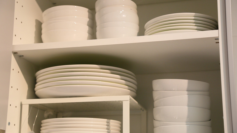 White dishes in cabinet