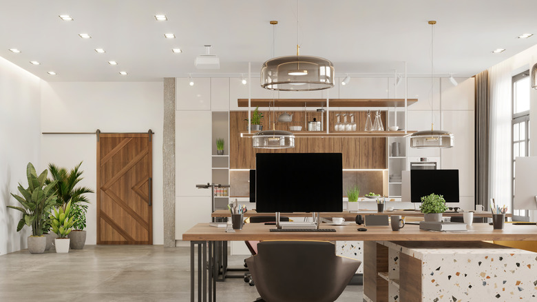 Dated office with wood barn door and terrazzo desks