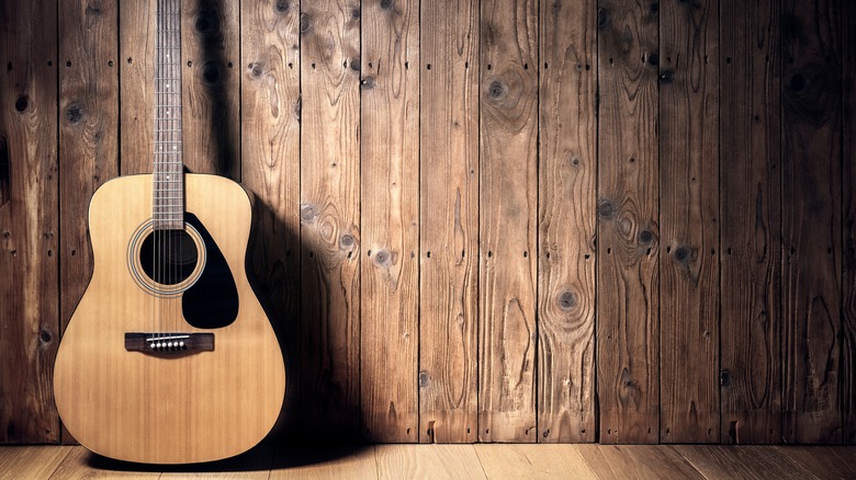 guitar against paneled wall